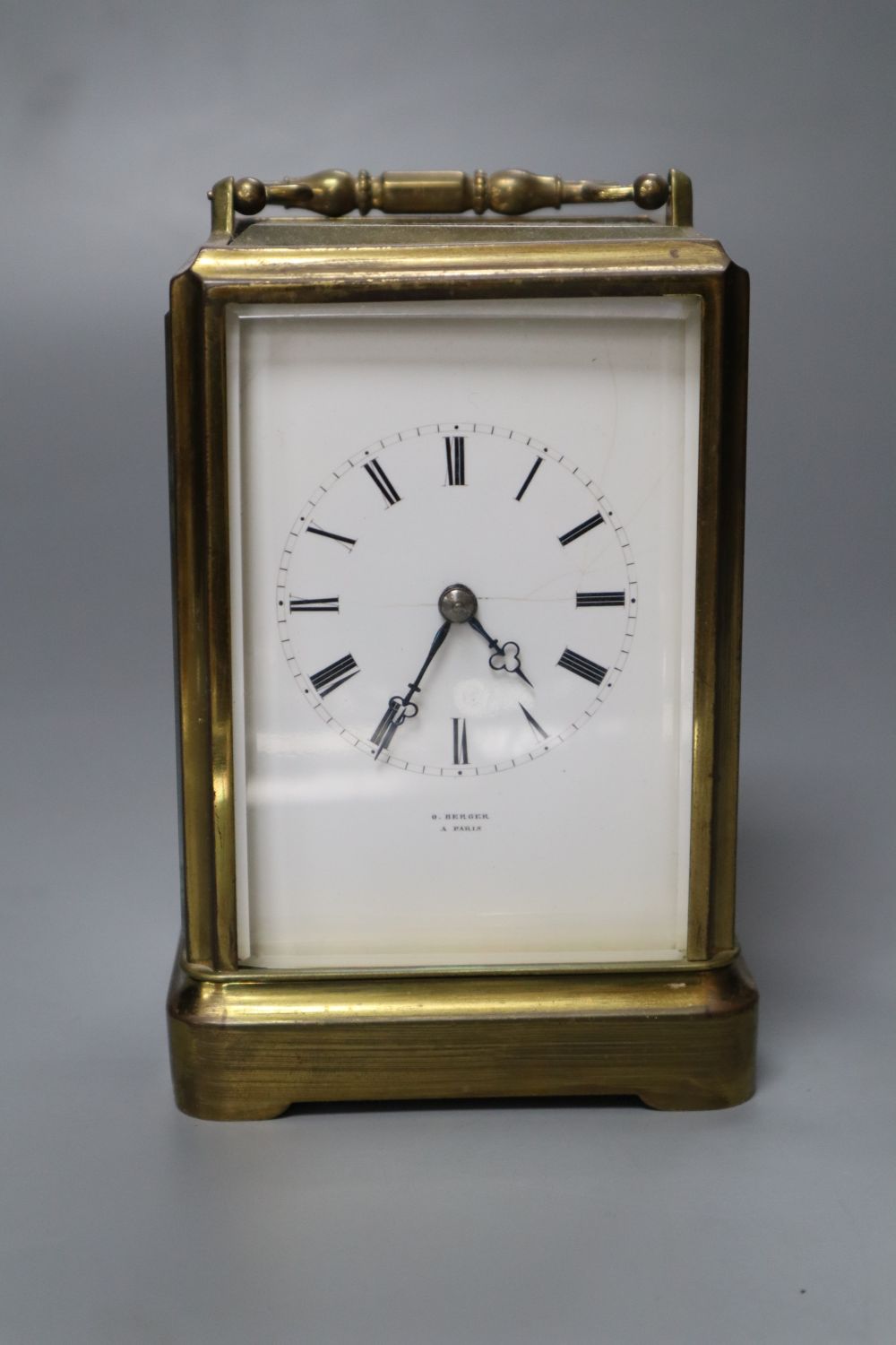 O. Berger, Paris. A carriage clock, with white enamel dial, Japy Freres movement striking on a bell, 19cm incl. handle
